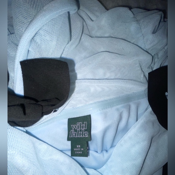 This is a blue dress with black bows, never worn, and super soft material. - Picture 2 of 3